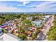Picturesque aerial view of a street market with tents, people, cars, and lush trees at 8058 Santa Cruz Dr, Port Charlotte, FL 33981