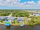 Aerial view of neighborhood homes featuring a pool and boat dock along a canal at 8058 Santa Cruz Dr, Port Charlotte, FL 33981