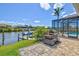 The backyard features an outdoor kitchen, a screened-in patio and dock access to the canal at 8058 Santa Cruz Dr, Port Charlotte, FL 33981
