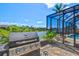 An outdoor grill and outdoor screened in patio space overlooking the canal at 8058 Santa Cruz Dr, Port Charlotte, FL 33981