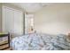 Guest bedroom featuring a wooden bed frame, ceiling fan, wood floors, and closet at 8058 Santa Cruz Dr, Port Charlotte, FL 33981