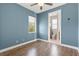 Blue room with light wood floors, window, and bathroom at 8058 Santa Cruz Dr, Port Charlotte, FL 33981