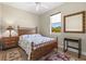 Guest bedroom featuring a wooden bed frame, ceiling fan, wood floors, and bedside decor at 8058 Santa Cruz Dr, Port Charlotte, FL 33981