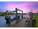 Dock featuring a well-maintained boat lift and a seating area, perfect for waterfront enjoyment at 8058 Santa Cruz Dr, Port Charlotte, FL 33981