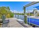 Dock featuring seating, a boat lift, and stunning views of the water and surrounding landscape at 8058 Santa Cruz Dr, Port Charlotte, FL 33981