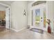 Bright foyer with tile flooring and a clear view of the well-manicured front lawn through the glass front door at 8058 Santa Cruz Dr, Port Charlotte, FL 33981