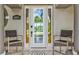 Elegant front door entrance framed by decorative columns, manicured landscaping, and tiled flooring at 8058 Santa Cruz Dr, Port Charlotte, FL 33981