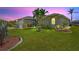 Beautiful home with a green lawn, highlighted by colorful plants and decorative lighting in the yard at 8058 Santa Cruz Dr, Port Charlotte, FL 33981