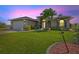 Inviting single-story home with manicured lawn, lush landscaping, and a welcoming front entrance at 8058 Santa Cruz Dr, Port Charlotte, FL 33981