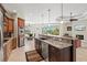 Open kitchen with island, stainless appliances, granite counters and view to dining area at 8058 Santa Cruz Dr, Port Charlotte, FL 33981