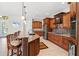 Kitchen island features seating, and granite countertops with view to stainless appliances at 8058 Santa Cruz Dr, Port Charlotte, FL 33981