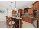 Kitchen island with seating features granite countertops and stainless steel appliances at 8058 Santa Cruz Dr, Port Charlotte, FL 33981