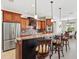 Kitchen with dark wood island, stone countertops, stainless appliances, and pendant lighting at 8058 Santa Cruz Dr, Port Charlotte, FL 33981