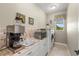 Laundry room features white cabinets, tile backsplash, window with view to the outdoors at 8058 Santa Cruz Dr, Port Charlotte, FL 33981