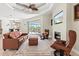 Cozy living room with a fireplace, tray ceiling, tile floors, and views of the outdoor pool area at 8058 Santa Cruz Dr, Port Charlotte, FL 33981