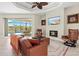 Comfortable living room with a fireplace, a large TV, comfortable seating, and views of the pool at 8058 Santa Cruz Dr, Port Charlotte, FL 33981