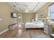 Bright main bedroom with trey ceiling, ceiling fan, and wood floors with a walkout to the pool at 8058 Santa Cruz Dr, Port Charlotte, FL 33981