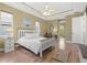 Bright main bedroom with trey ceiling, ceiling fan, wood floors, and a connecting sitting area at 8058 Santa Cruz Dr, Port Charlotte, FL 33981