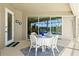 Charming patio with seating, complemented by serene views of the screened pool and surrounding landscape at 8058 Santa Cruz Dr, Port Charlotte, FL 33981