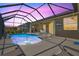 Inviting in-ground pool with a screened enclosure and a view of the beautiful backyard at 8058 Santa Cruz Dr, Port Charlotte, FL 33981