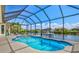 Inviting in-ground pool in screened enclosure with waterfront views at 8058 Santa Cruz Dr, Port Charlotte, FL 33981