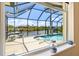 View of the screened pool and canal at 8058 Santa Cruz Dr, Port Charlotte, FL 33981