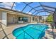 In-ground pool in screened enclosure with outdoor dining at 8058 Santa Cruz Dr, Port Charlotte, FL 33981