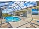 In-ground pool and seating in screened enclosure with dining and lounging spaces at 8058 Santa Cruz Dr, Port Charlotte, FL 33981