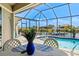 Enclosed pool with dining area overlooking the canal at 8058 Santa Cruz Dr, Port Charlotte, FL 33981