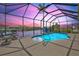 Screened-in pool area with comfortable seating and view of the serene waterfront at 8058 Santa Cruz Dr, Port Charlotte, FL 33981