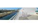 Balcony view overlooking a canal with boats docked, palm trees, and residential buildings in the distance at 8222 Harborside Cir, Englewood, FL 34224