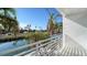 Balcony view featuring lush palm trees, a canal, and boat storage; a relaxing outdoor space at 8222 Harborside Cir, Englewood, FL 34224
