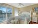 Bright bedroom featuring a queen bed, sliding glass doors to a balcony, ceiling fan, and modern furnishings at 8222 Harborside Cir, Englewood, FL 34224