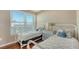 Bedroom featuring two twin beds, a dresser, and a large window with blind and pretty hardwood floors at 8222 Harborside Cir, Englewood, FL 34224