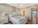 Bedroom with a queen bed, hardwood floors, side tables, and a view of a bathroom at 8222 Harborside Cir, Englewood, FL 34224