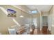 The dining area features a high ceiling, wood floors, and plenty of natural light at 8222 Harborside Cir, Englewood, FL 34224