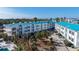 This exterior shows the condo complex with blue roofs, palm trees, and parking at 8222 Harborside Cir, Englewood, FL 34224