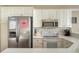 Bright kitchen featuring white cabinets, stainless steel appliances, and updated countertops at 8222 Harborside Cir, Englewood, FL 34224