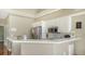 Bright kitchen featuring white cabinets, stainless steel appliances, and a breakfast bar at 8222 Harborside Cir, Englewood, FL 34224