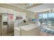 The bright kitchen features white cabinets, stainless appliances, and breakfast bar at 8222 Harborside Cir, Englewood, FL 34224