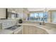 Updated kitchen featuring white cabinets and countertops with stainless steel appliances at 8222 Harborside Cir, Englewood, FL 34224