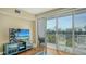 Bright living room with a television and a sliding glass door leading to the outside at 8222 Harborside Cir, Englewood, FL 34224