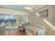 Bright living room with wood floors and access to a spacious outdoor balcony at 8222 Harborside Cir, Englewood, FL 34224