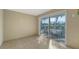 Sunroom with sliding glass doors opening to the outside patio with room for outdoor seating at 8222 Harborside Cir, Englewood, FL 34224