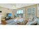 Cozy living room with a ceiling fan, wood floors, and a sliding glass door to the outside at 8222 Harborside Cir, Englewood, FL 34224