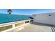 This shows the roof with a green top, white walls, windows, and tiled floors; view of rooftop space at 8222 Harborside Cir, Englewood, FL 34224