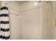 Shower featuring white tile walls and shower head with blue striped shower curtain to the left at 8222 Harborside Cir, Englewood, FL 34224