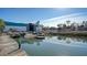 Beautiful waterfront view featuring docks, boats, and a boat storage facility under a sunny sky at 8222 Harborside Cir, Englewood, FL 34224