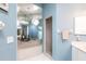 Bright blue bathroom featuring a soaking tub, framed mirrors, and a walk-in shower at 832 Carnoustie Dr, Venice, FL 34293