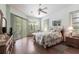 Bedroom featuring decorative bedding, light green walls, and lots of natural light with sliders to lanai at 832 Carnoustie Dr, Venice, FL 34293